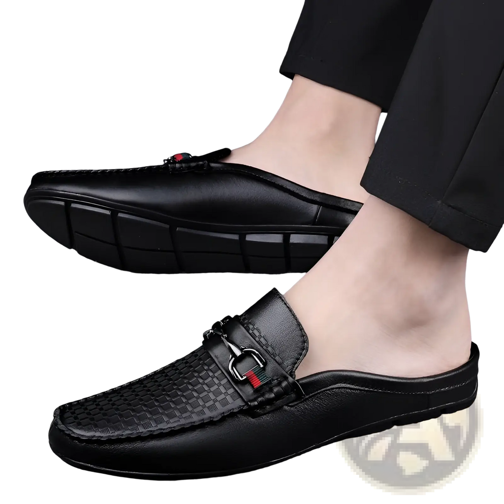 Men’s black leather mule loafers with woven texture on toe and silver buckle accent with red and green detailing