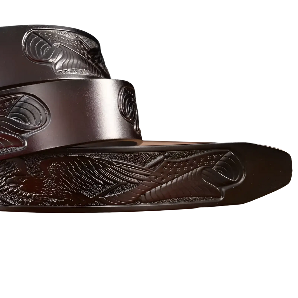 Men’s dark brown leather ratchet belt with engraved eagle designs featuring detailed feathers and wings