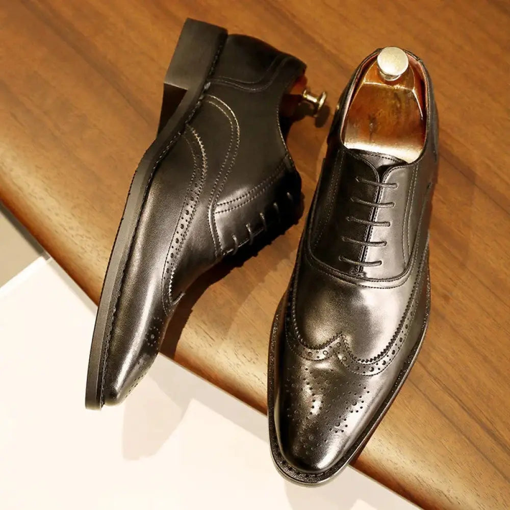 Men’s black leather brogue oxford shoes with perforated detailing and polished finish featuring a rubber sole