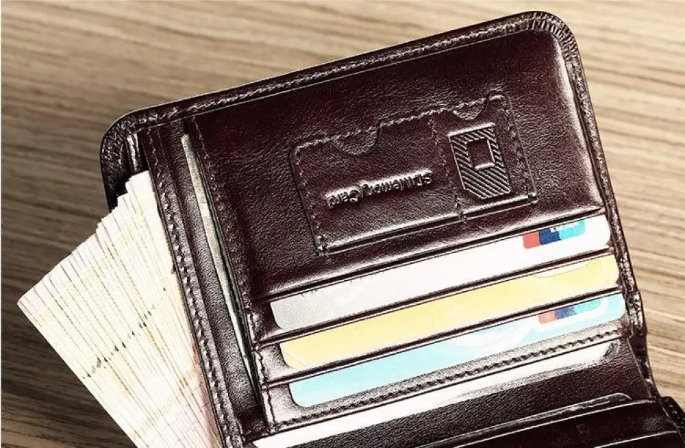 Men’s brown leather tri-fold wallet with embossed logo and multiple card slots holding colorful cards