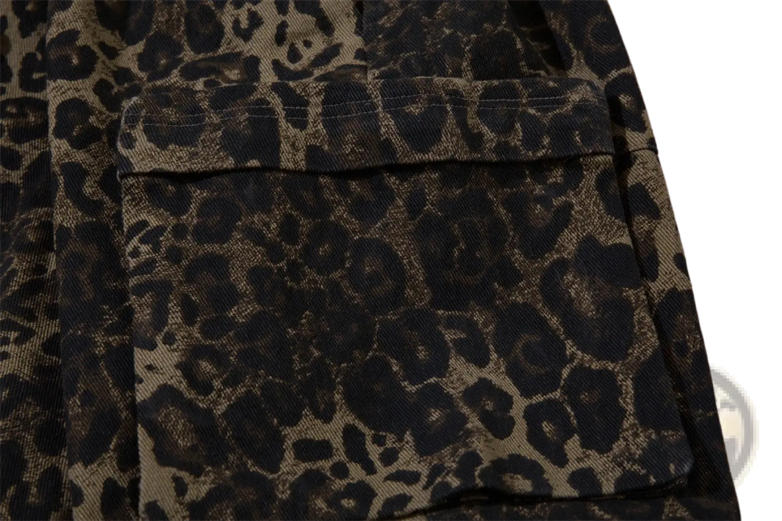 Men’s leopard print denim and cargo workwear shorts featuring a black and tan leopard print cargo pocket on textured fabric