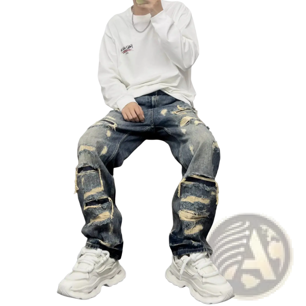 Men’s light blue distressed ripped patch denim jeans in dark blue with multiple ripped patches and frayed edges