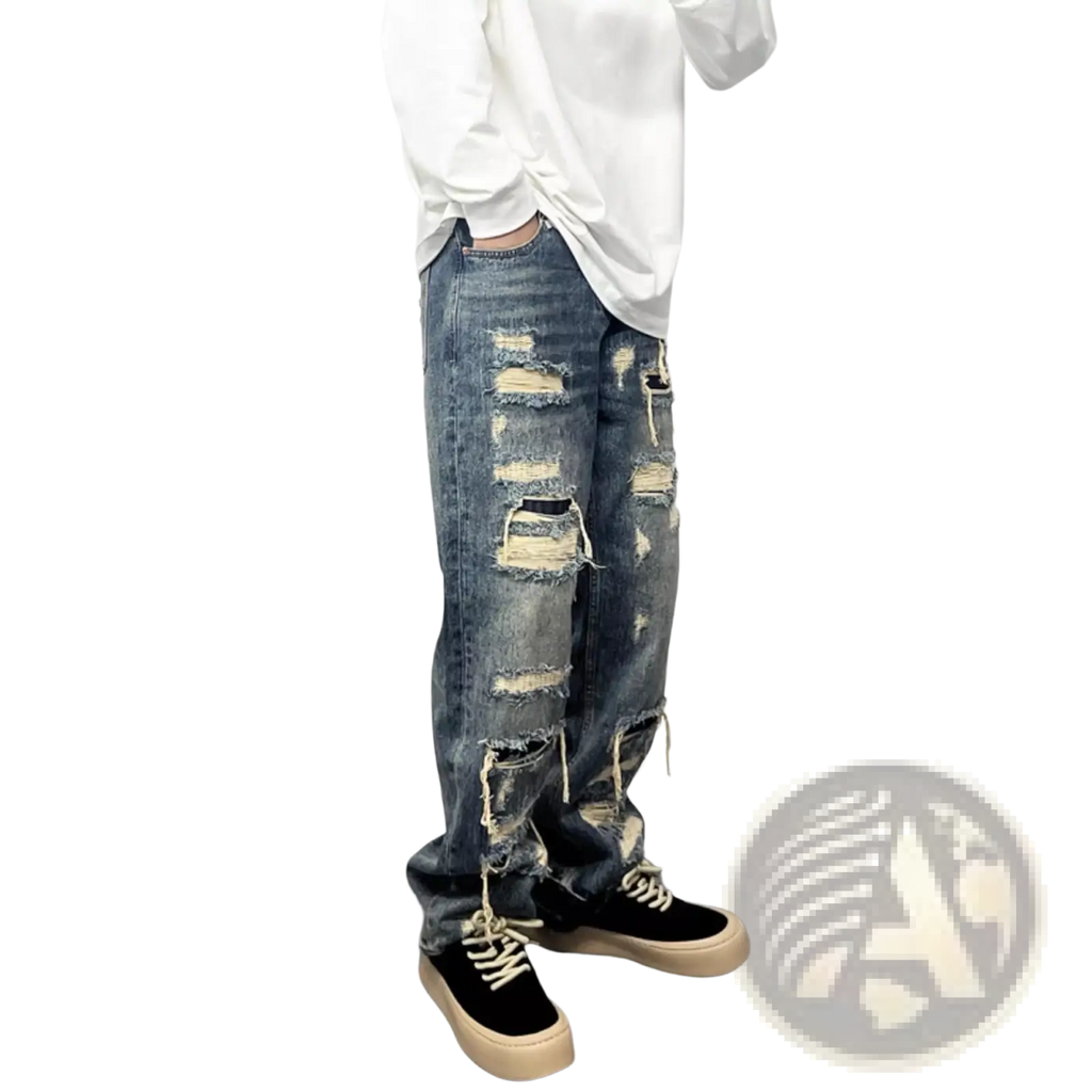 Men’s light blue distressed ripped patch denim jeans featuring multiple frayed and torn areas along the legs