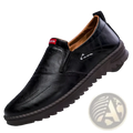 Black lightweight breathable faux leather men’s slip-on shoe with textured surface tan lining and red heel label back view