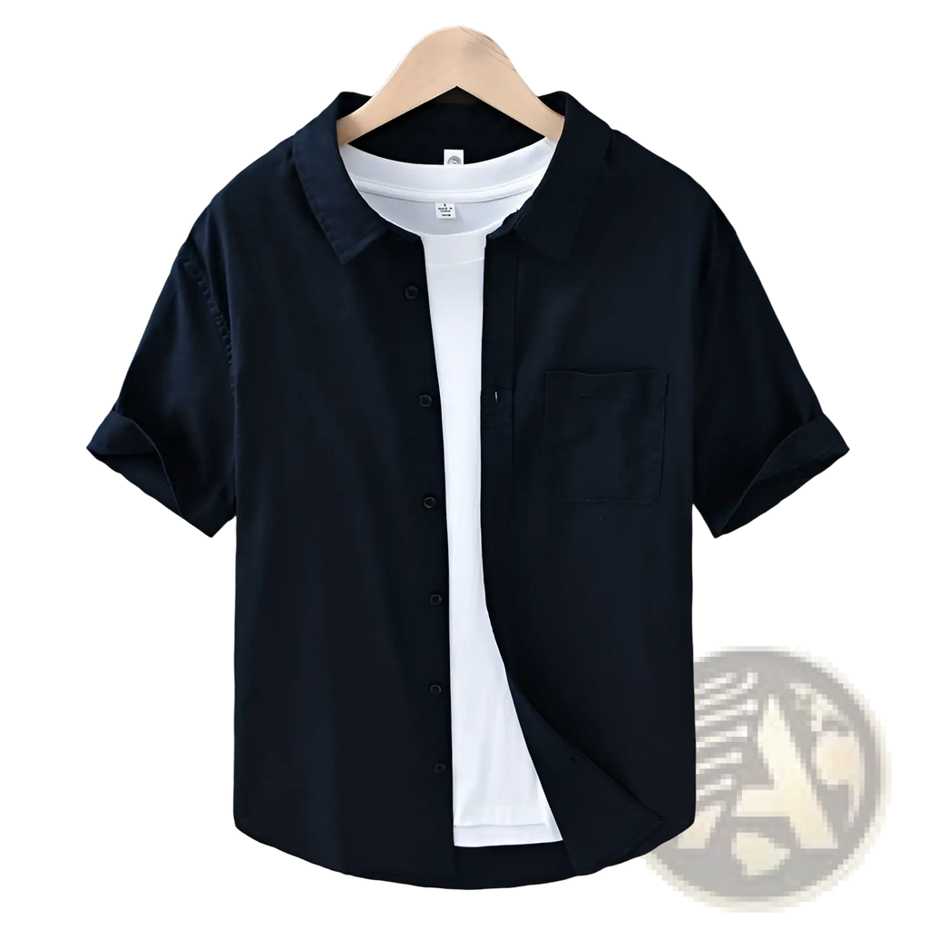 Men’s lightweight loose fit black linen short sleeve button-up shirt with chest pocket and rolled cuffs worn over white tee
