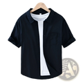 Men’s lightweight loose fit black linen short sleeve button-up shirt with chest pocket and rolled cuffs worn over white tee