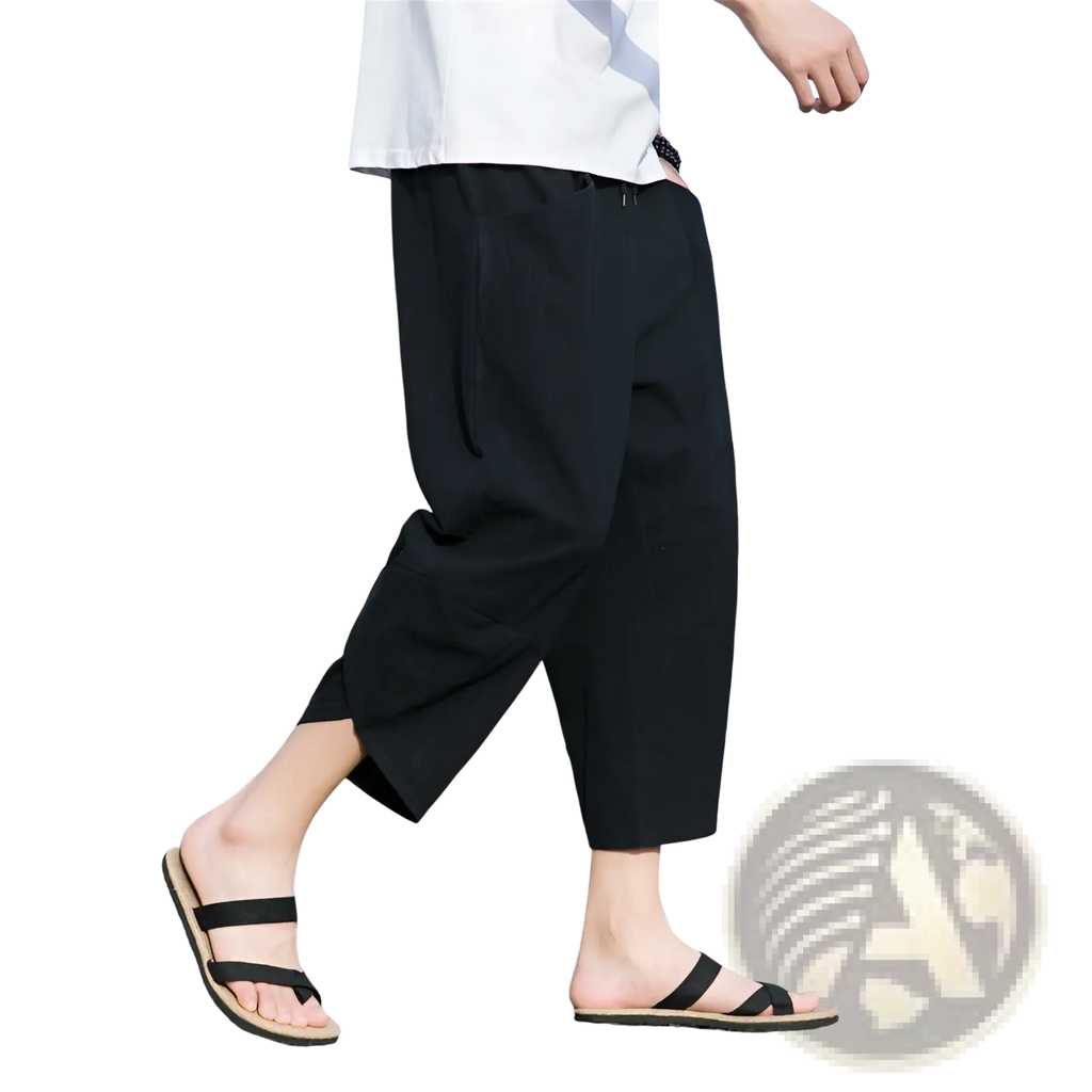 Black loose-fitting cotton men’s linen casual beach pants with a relaxed tapered cut and side pockets