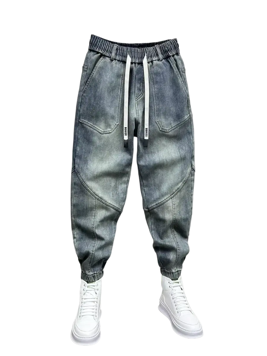 Mens loose denim harem pants in light-wash denim with a drawstring waist and white cord accents