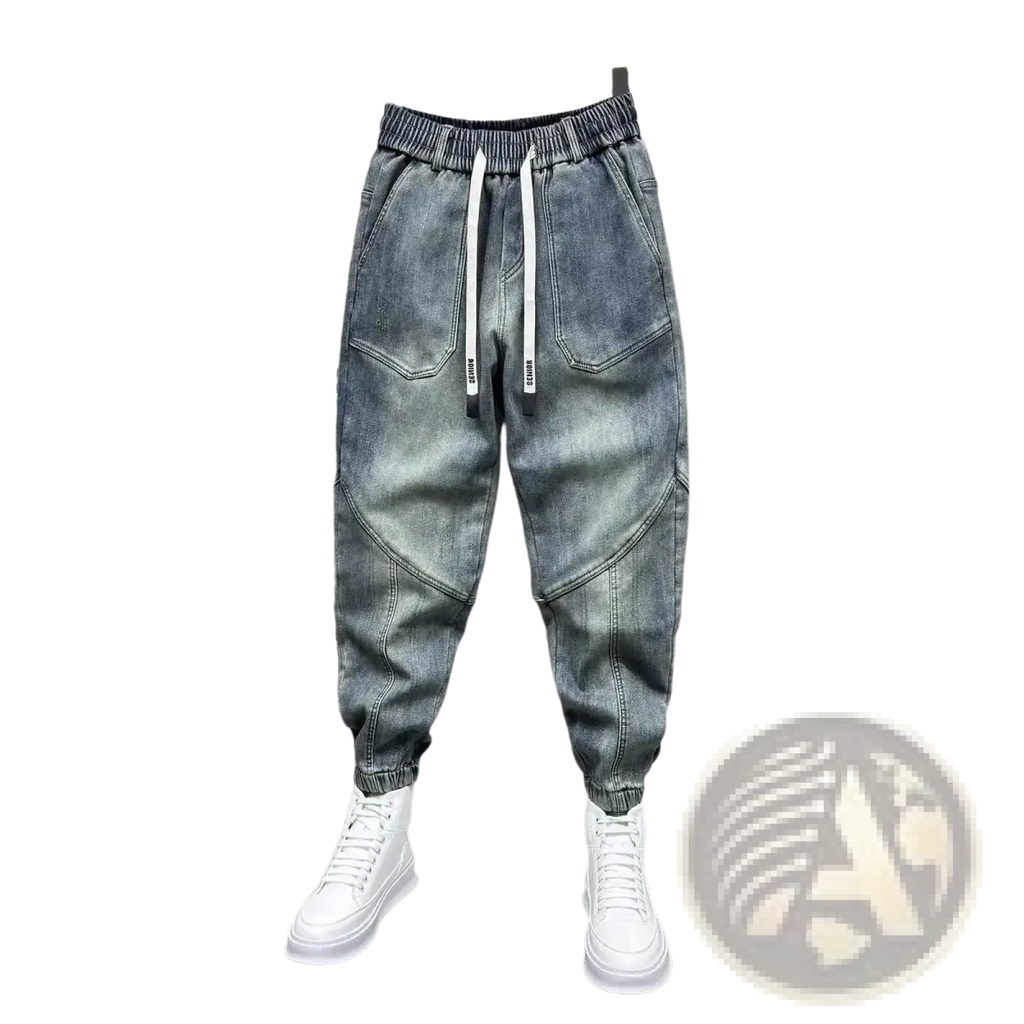 Mens loose denim harem pants in light-wash denim with a relaxed fit elastic waistband and white drawstrings