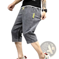 Men’s loose grey denim shorts with bright yellow drawstring and pocket tags for summer casual workwear