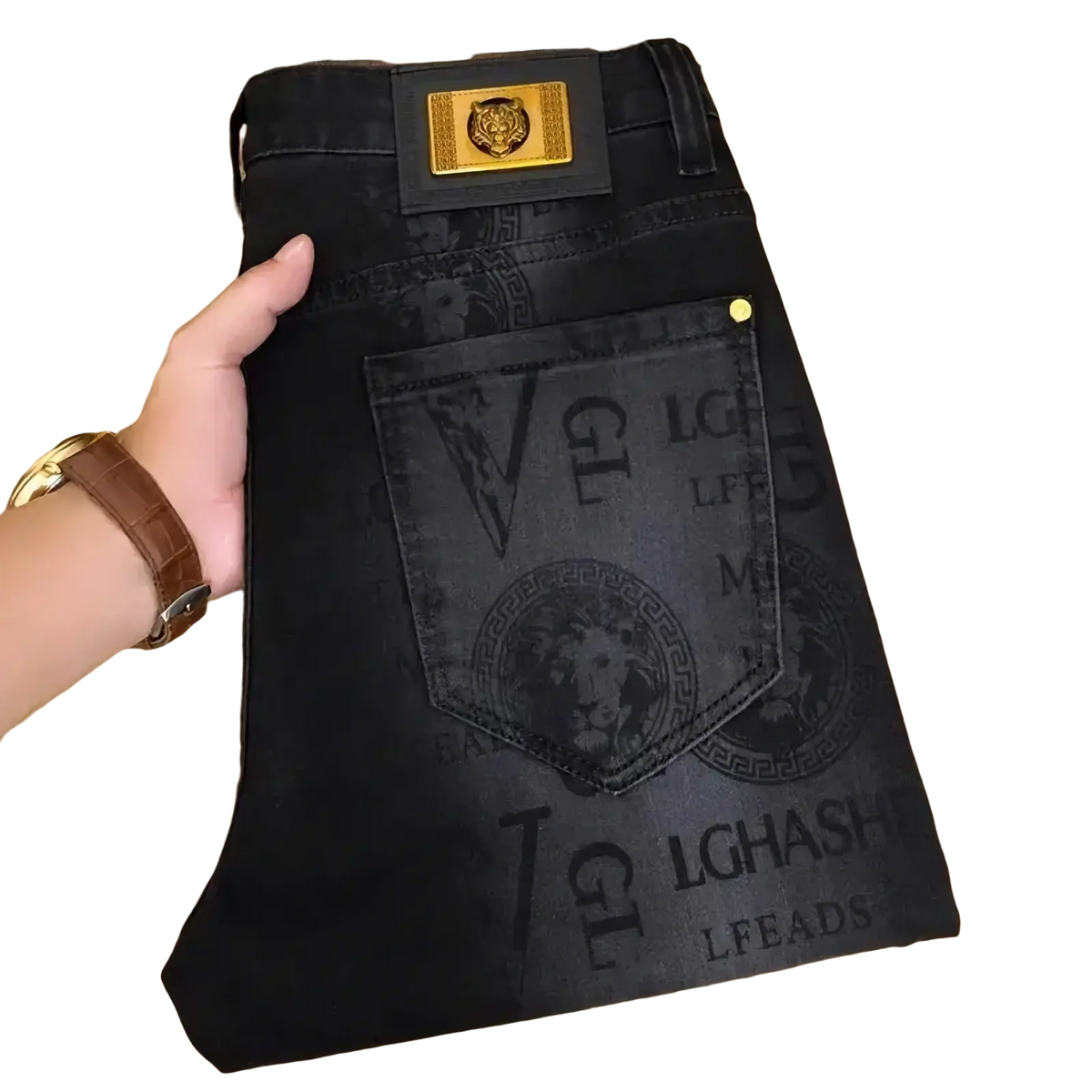 Men’s black denim jeans with gold tiger emblem on waistband and medusa head prints front loose fit straight leg