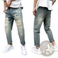 Men’s loose fit distressed straight leg light-wash denim jeans with ripped details on thighs and knees