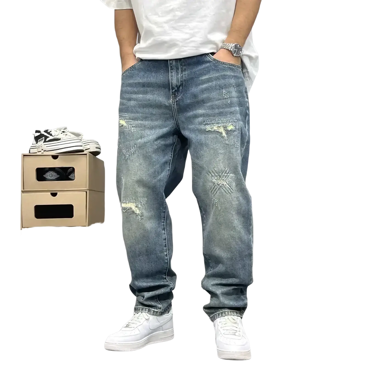 Men’s loose fit distressed straight leg denim jeans in medium wash with intentional rips and faded patches