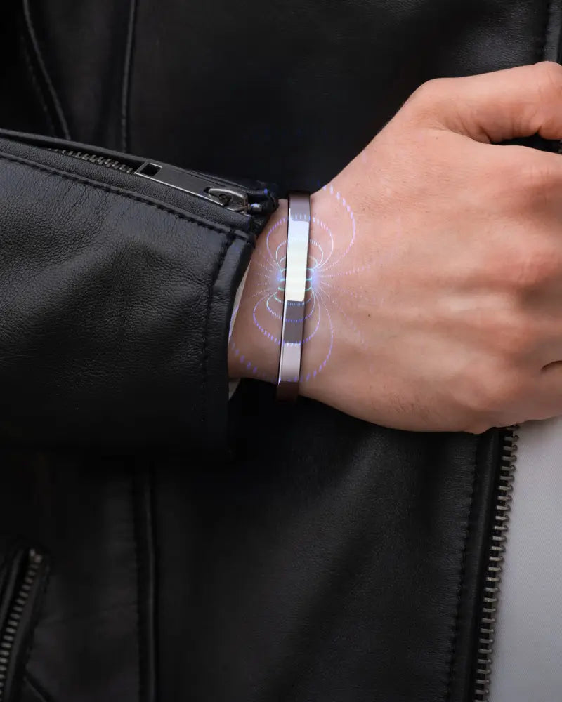 Men’s polished silver magnetic therapy cuff bracelet with a sleek rectangular design and a glowing blue light effect