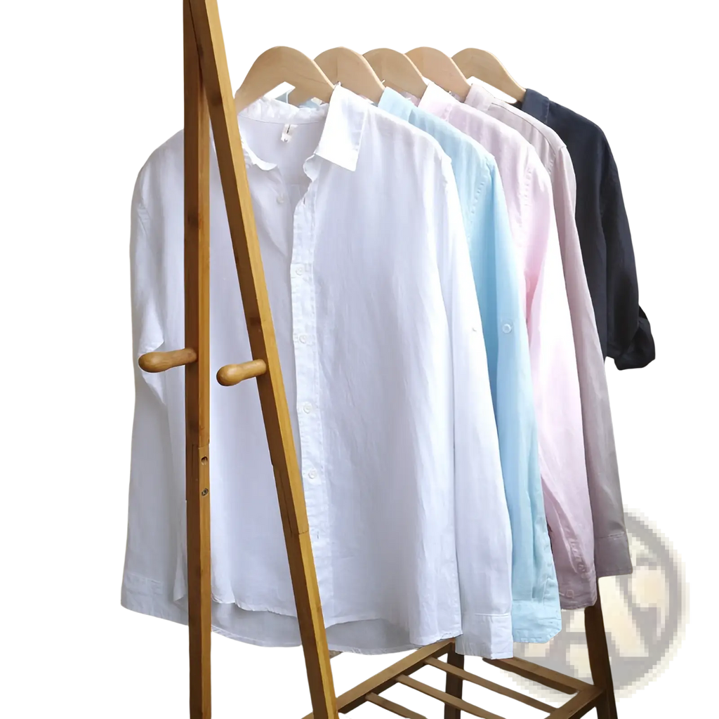 A row of men’s premium 100% linen long sleeve casual shirts in white light blue pink and navy hanging on a wooden rack