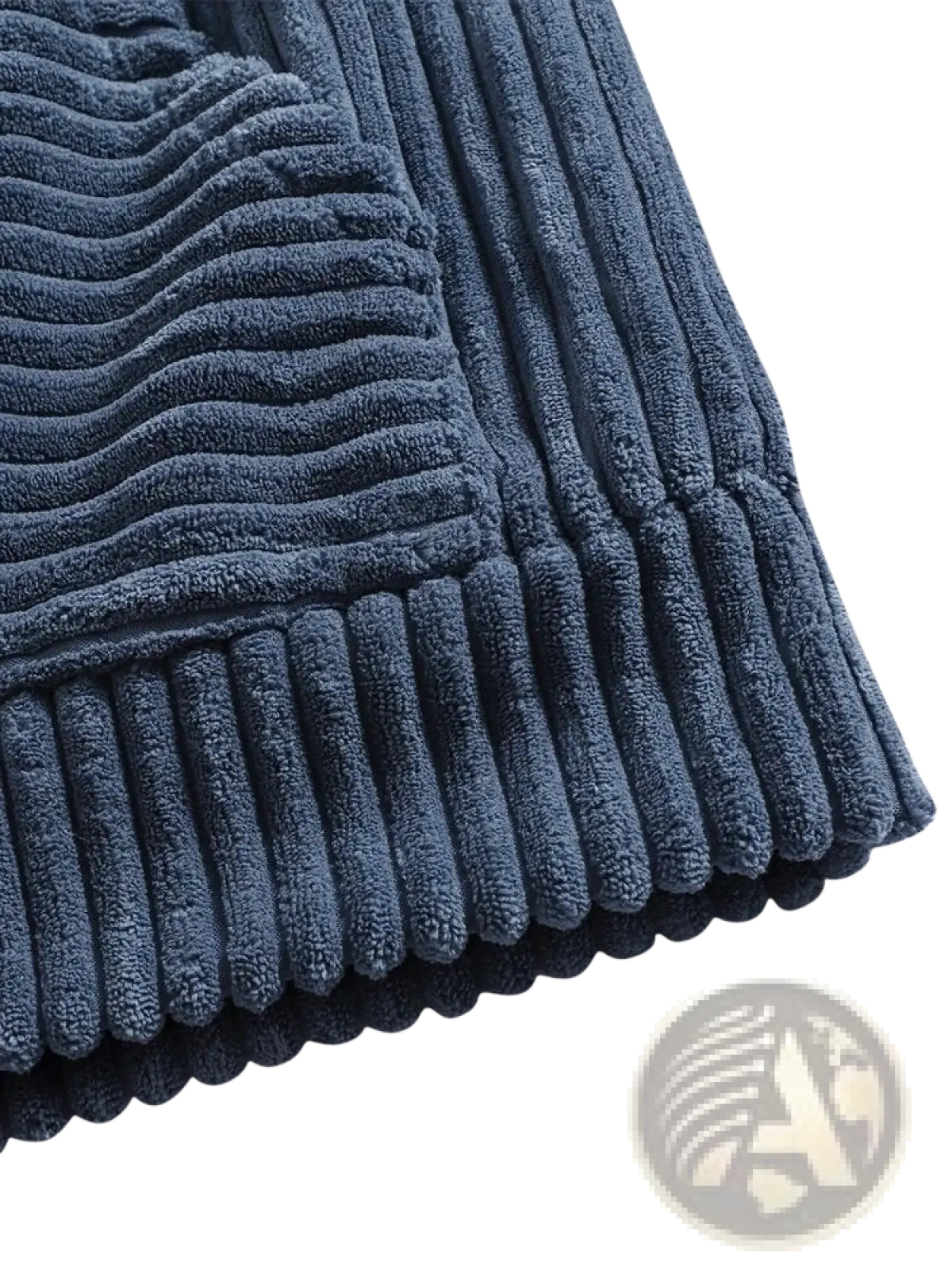 Navy blue corduroy bath mat with ribbed texture and scalloped edge