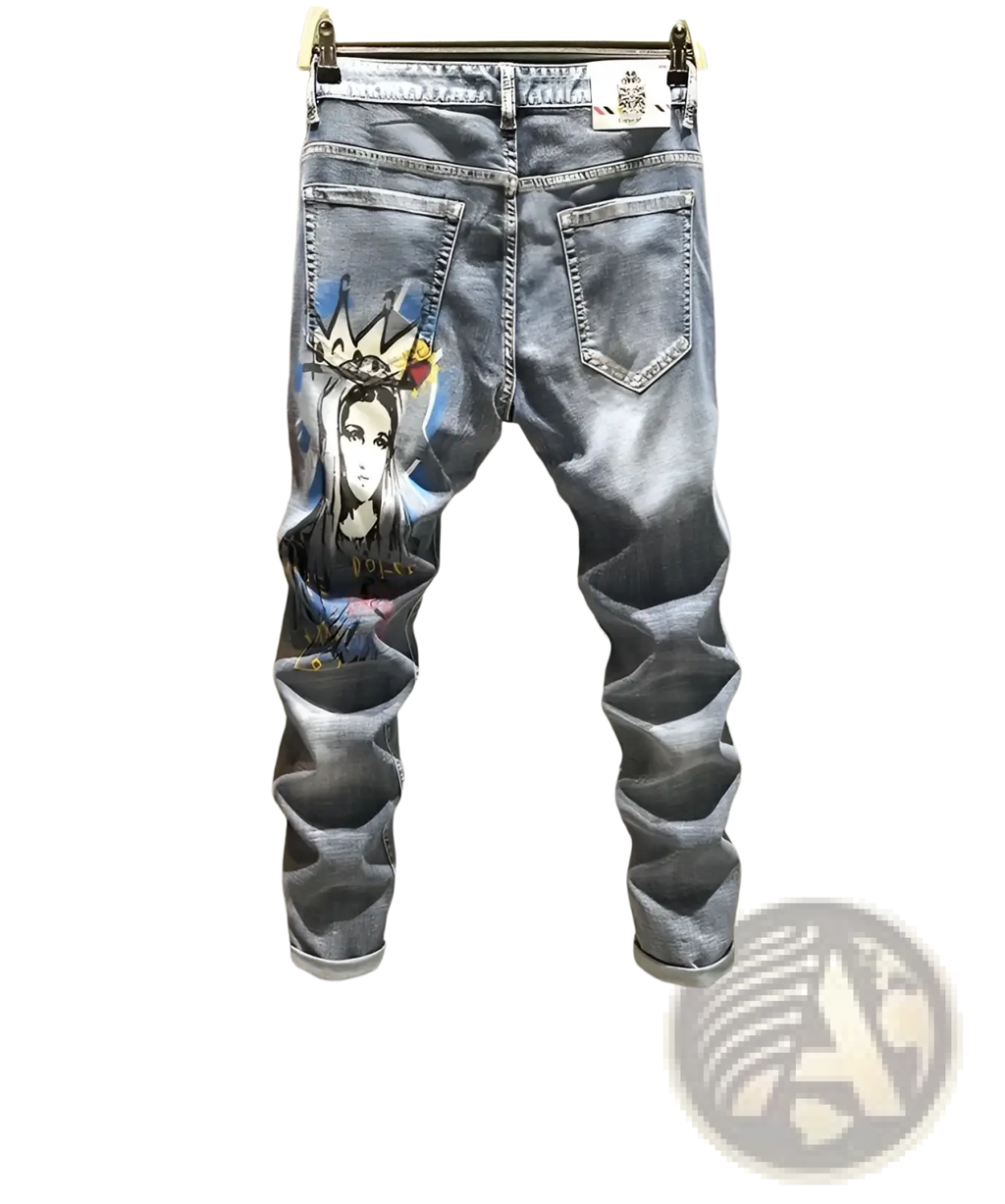 Men’s blue denim printed stretch slim jeans featuring a detailed graphic of a crowned figure on the left thigh