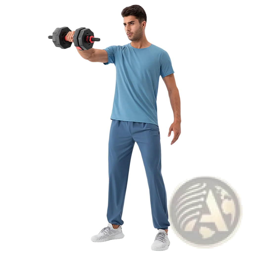 Man wearing blue quick dry nylon loose fit athletic track pants holding black and red hexagonal dumbbell