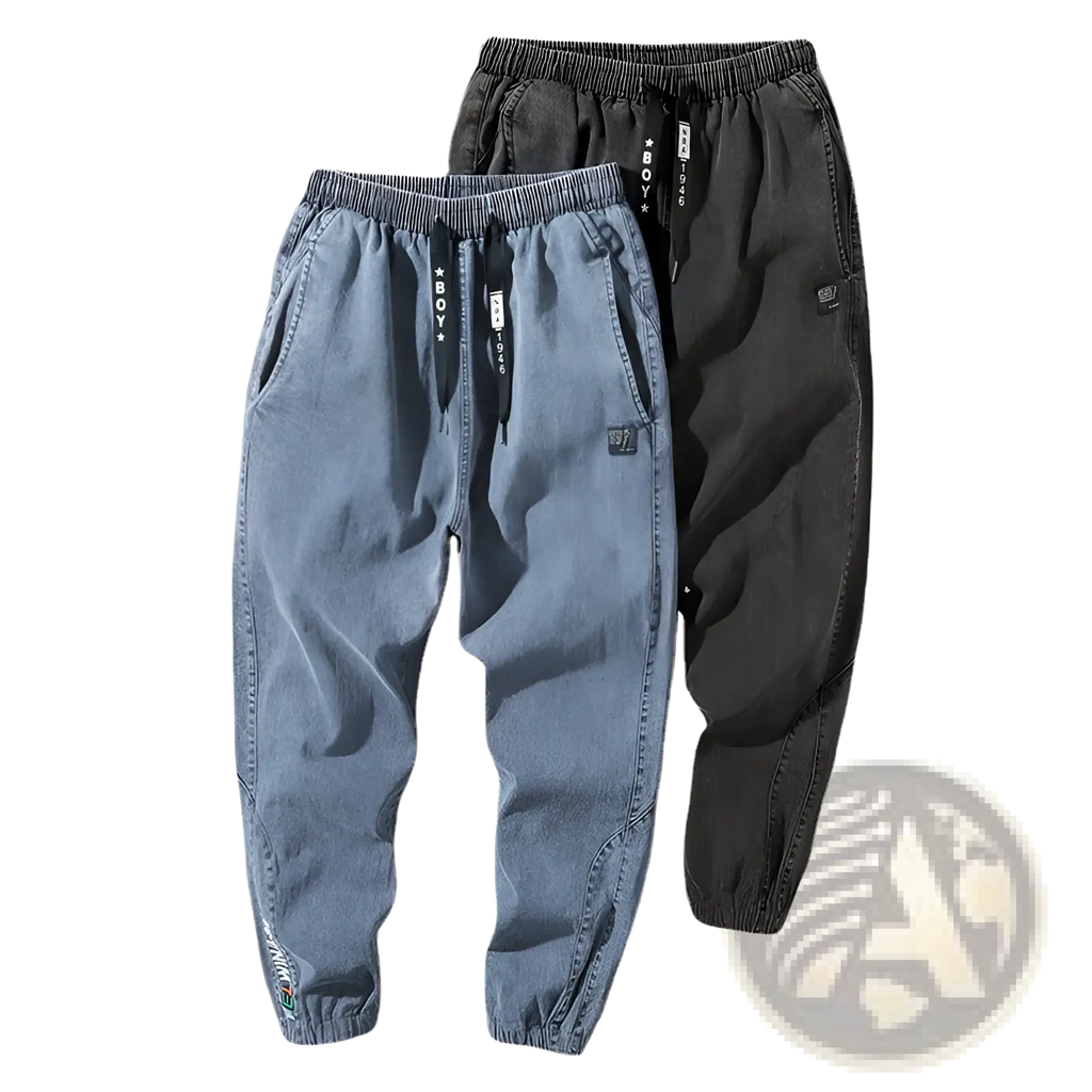Men’s relaxed fit denim joggers in blue and black with elastic waistband drawstring and subtle patch details