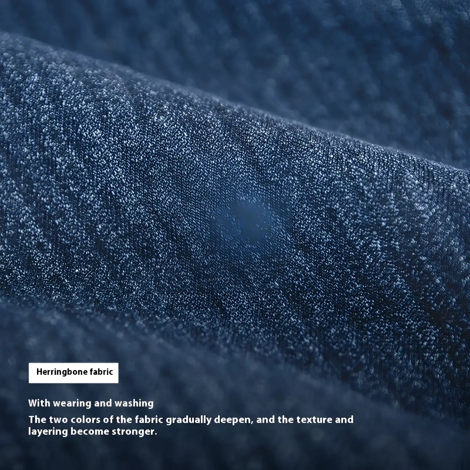 Men’s relaxed tapered dark blue denim jeans detail showing dark blue herringbone fabric with textured woven pattern