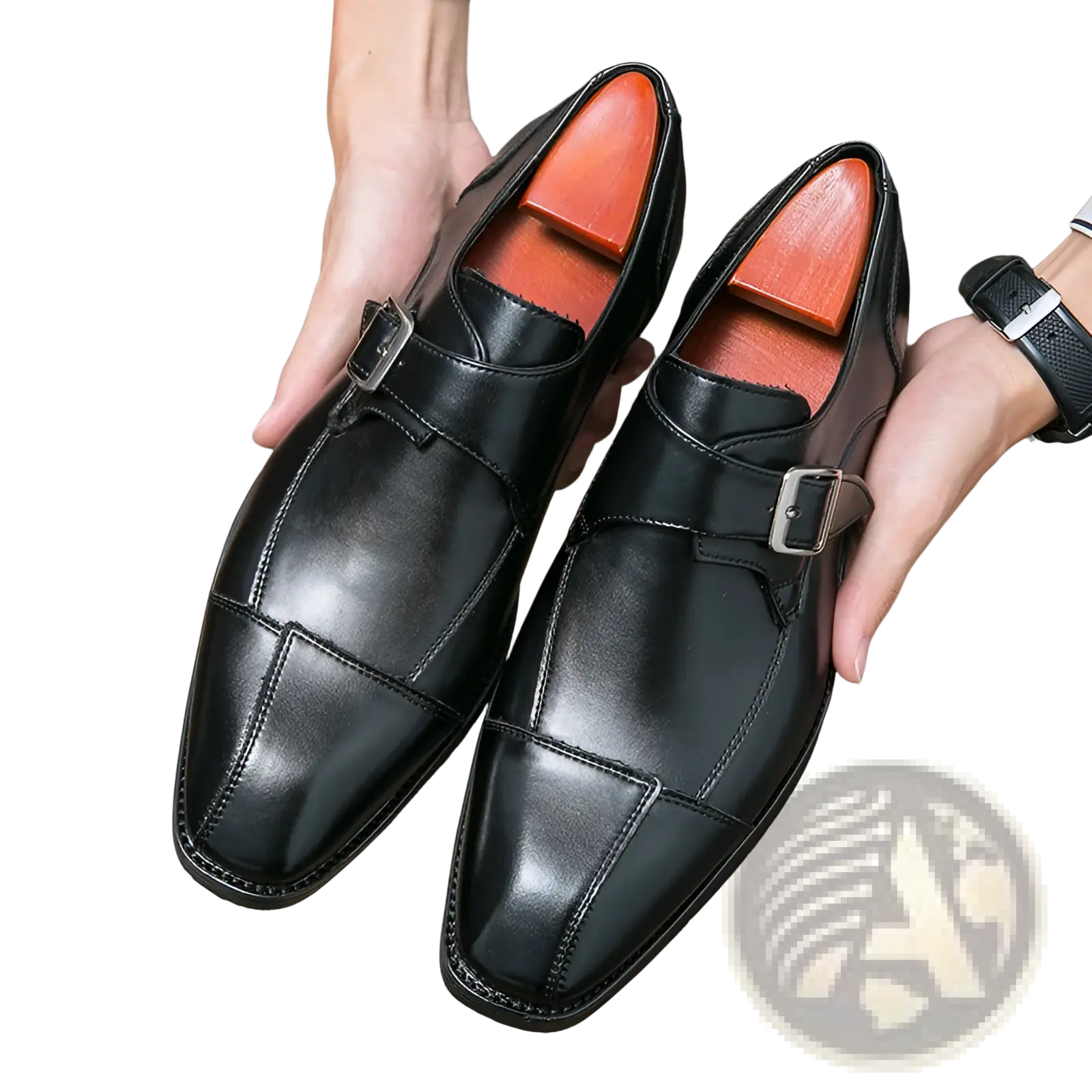 Black leather monk strap shoes with silver buckles and orange insoles.