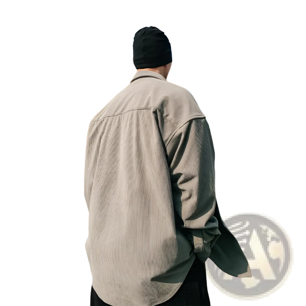 A man wearing a men’s retro loose fit corduroy utility shirt jacket in light gray with long sleeves and a black beanie