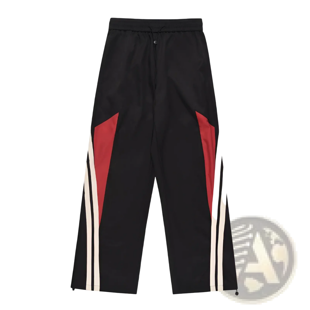 Men’s retro striped athletic track pants in black with bold red and white diagonal stripes on the sides