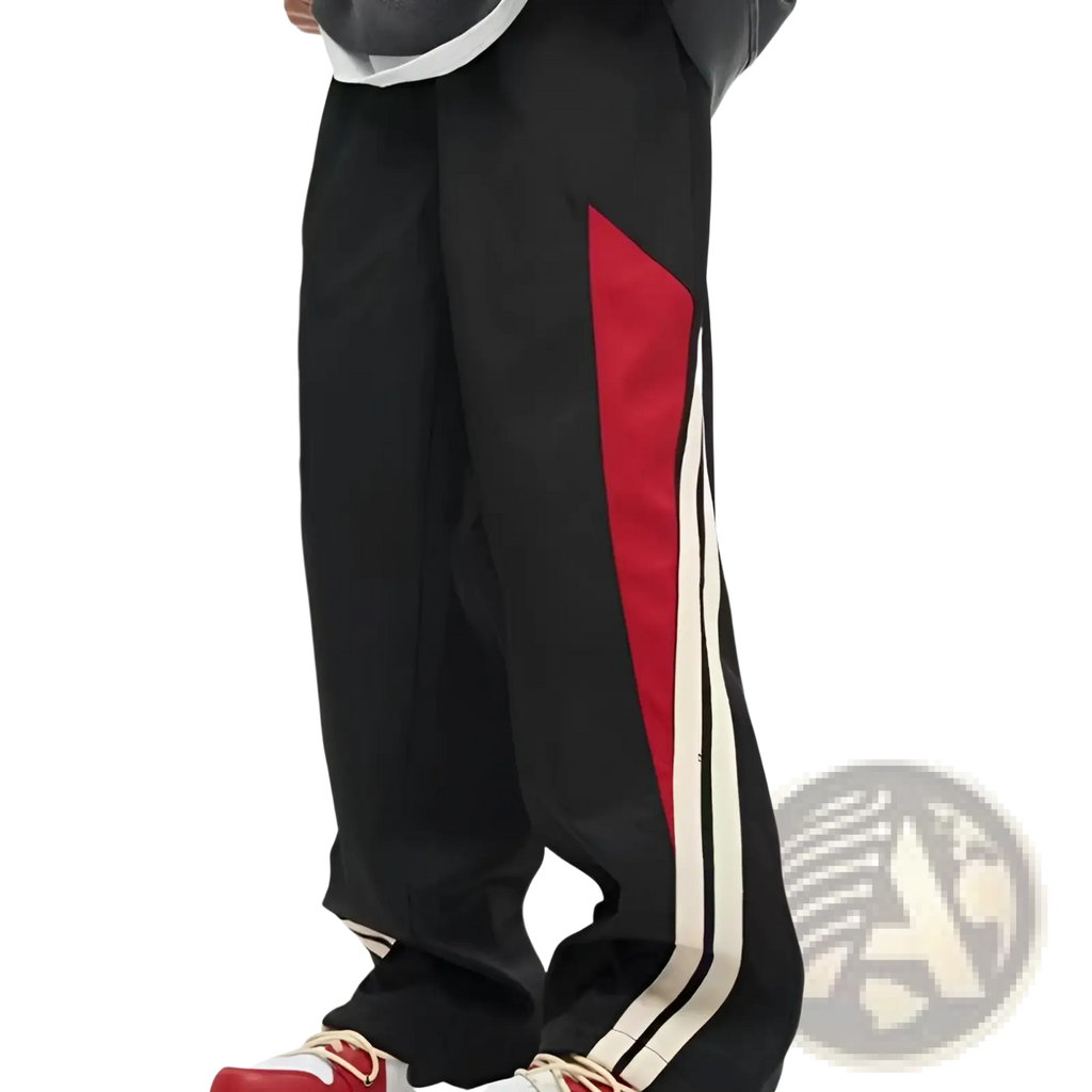 Men’s retro striped athletic track pants in black with a bold red diagonal and two parallel white side stripes