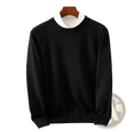 Men’s black ribbed crewneck pullover sweater with ribbed cuffs and hem displayed over white collared shirt on wooden hanger