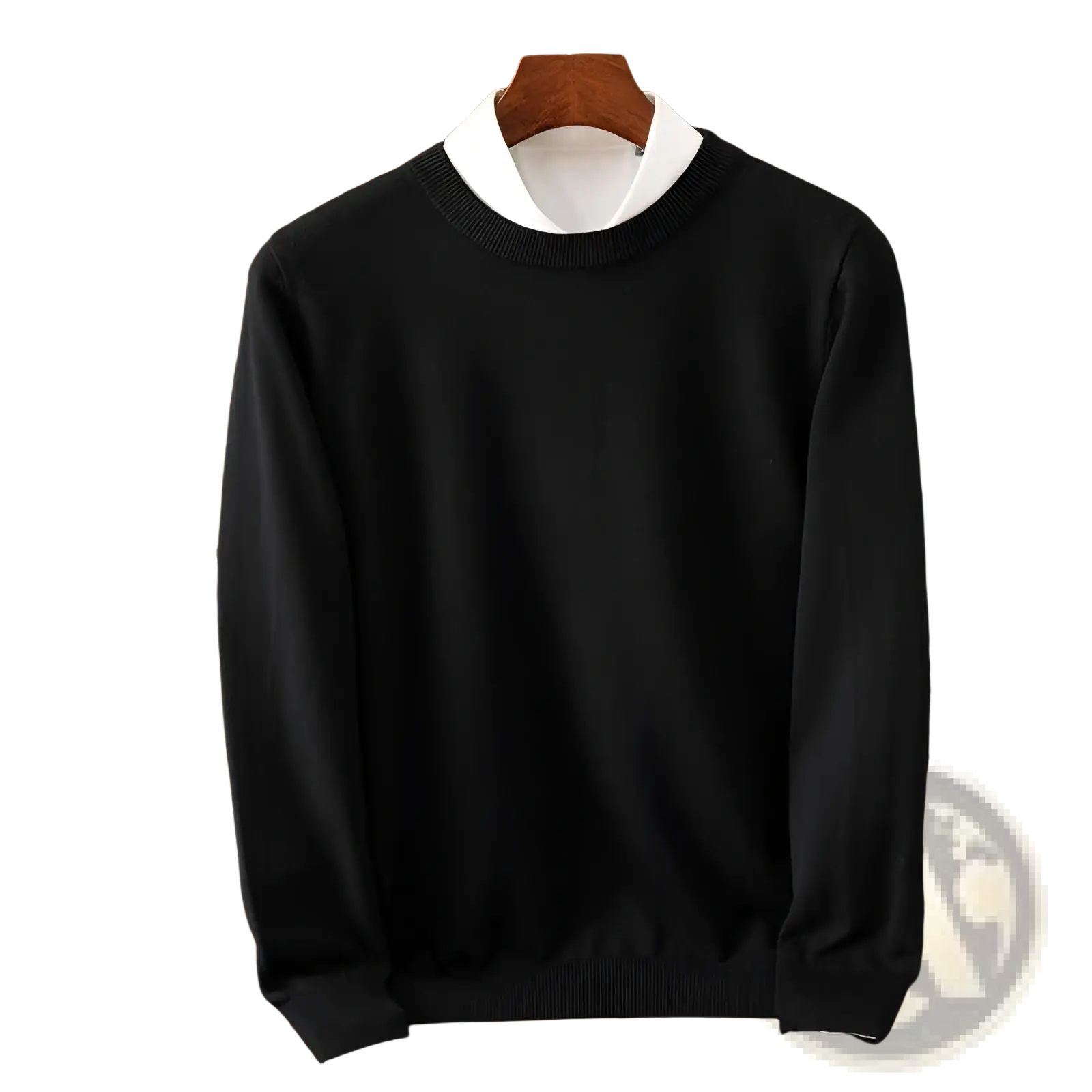 Men’s black ribbed crewneck pullover sweater with ribbed cuffs and hem displayed over white collared shirt on wooden hanger