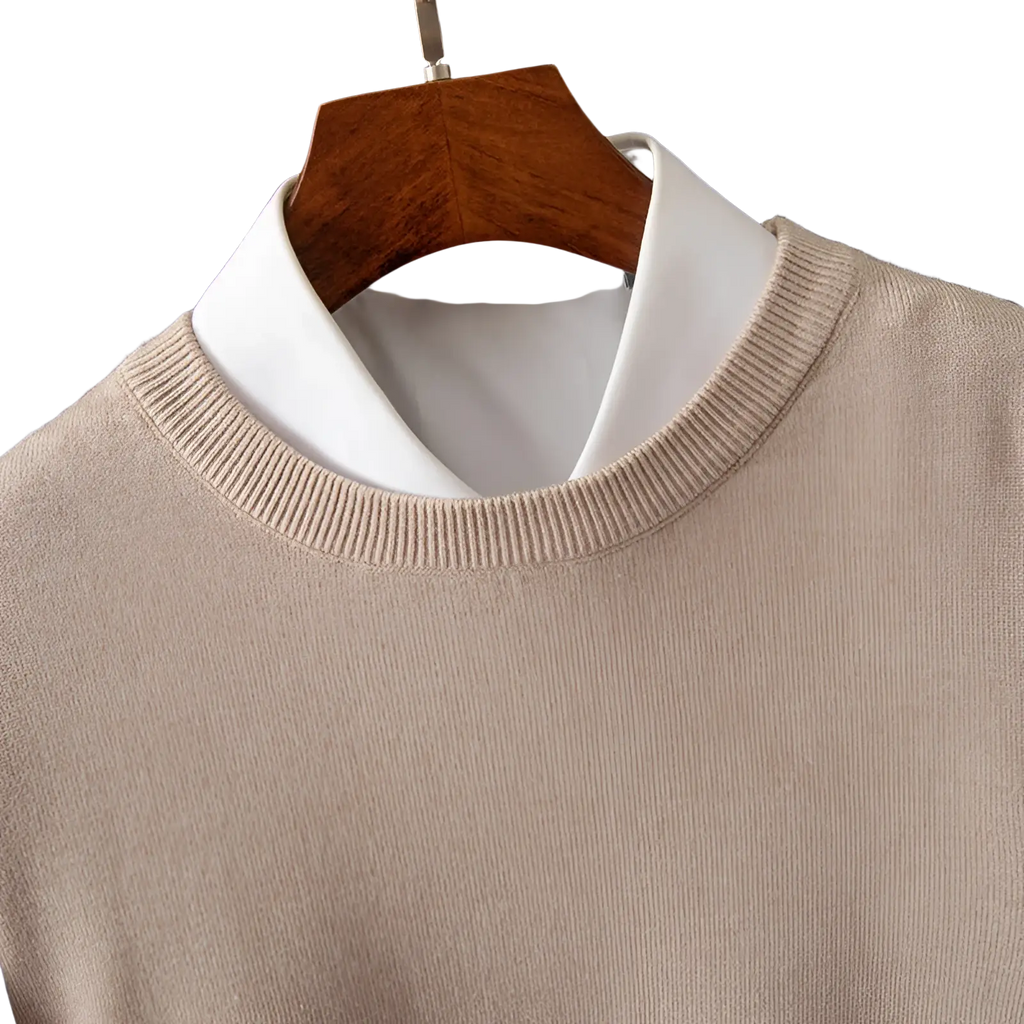 Beige ribbed-knit crewneck pullover sweater made of knit material worn over a white collared shirt for men