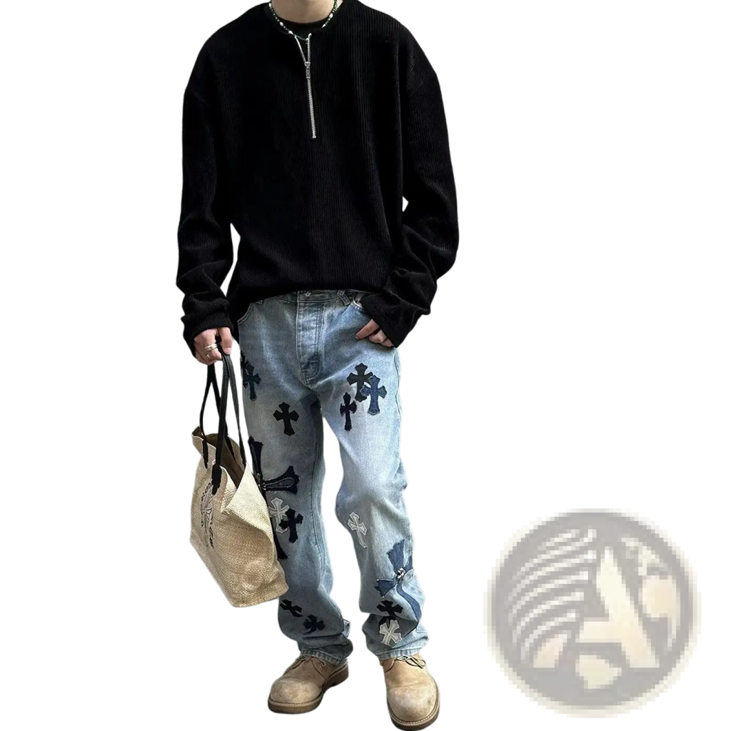 Men’s ribbed half-zip pullover sweater shown with light-wash denim jeans featuring black and white embroidered crosses