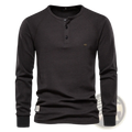 Black mens ribbed henley long sleeve shirt with a ribbed texture and three black buttons on the front