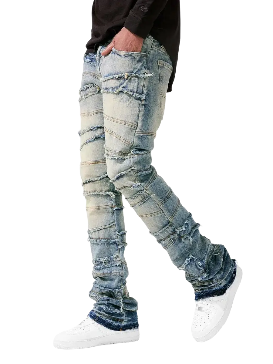 Men’s ripped stacked denim jeans in distressed blue with layered frayed patches and slim fit for streetwear