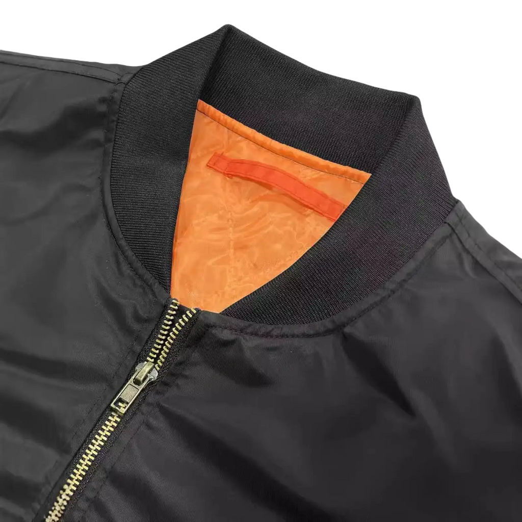 Men’s satin bomber jacket in black with vibrant orange contrast lining and gold toned zipper for stylish outerwear