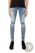 Men’s slim fit light-wash denim jeans with distressed ripped knees and black and white bandana-style patches