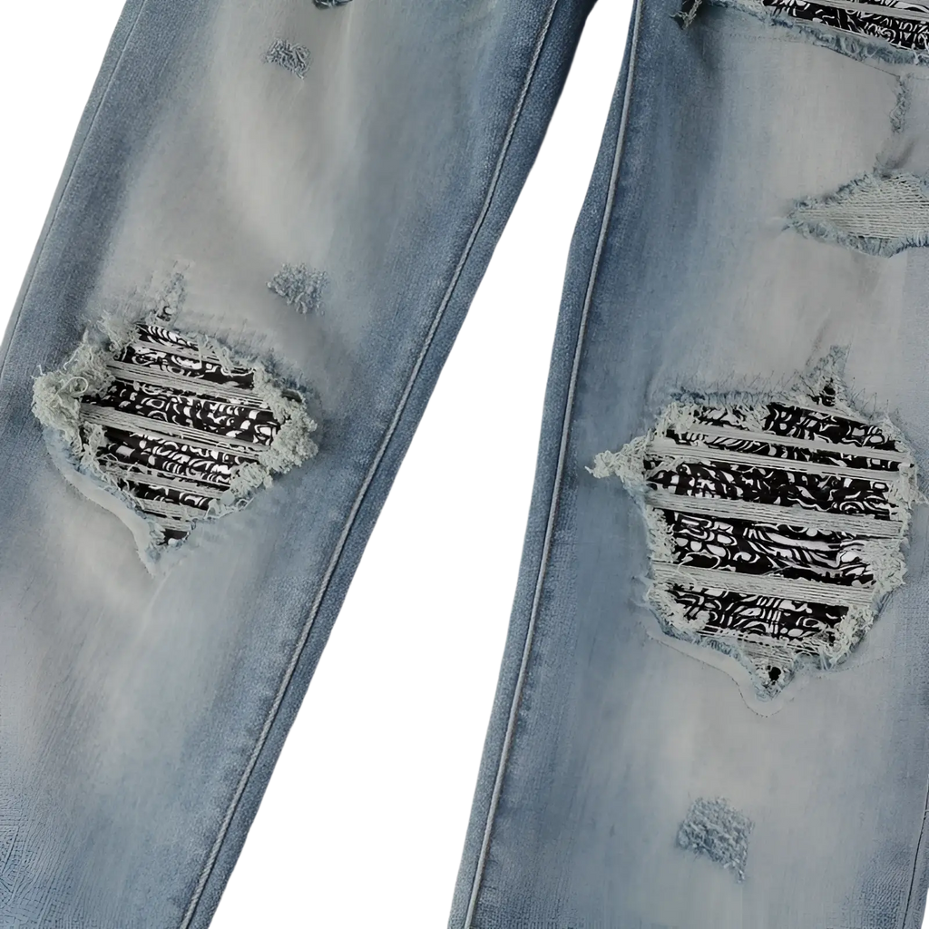 Men’s slim fit light wash denim jeans with distressed ripped knees and black and white bandana fabric inserts