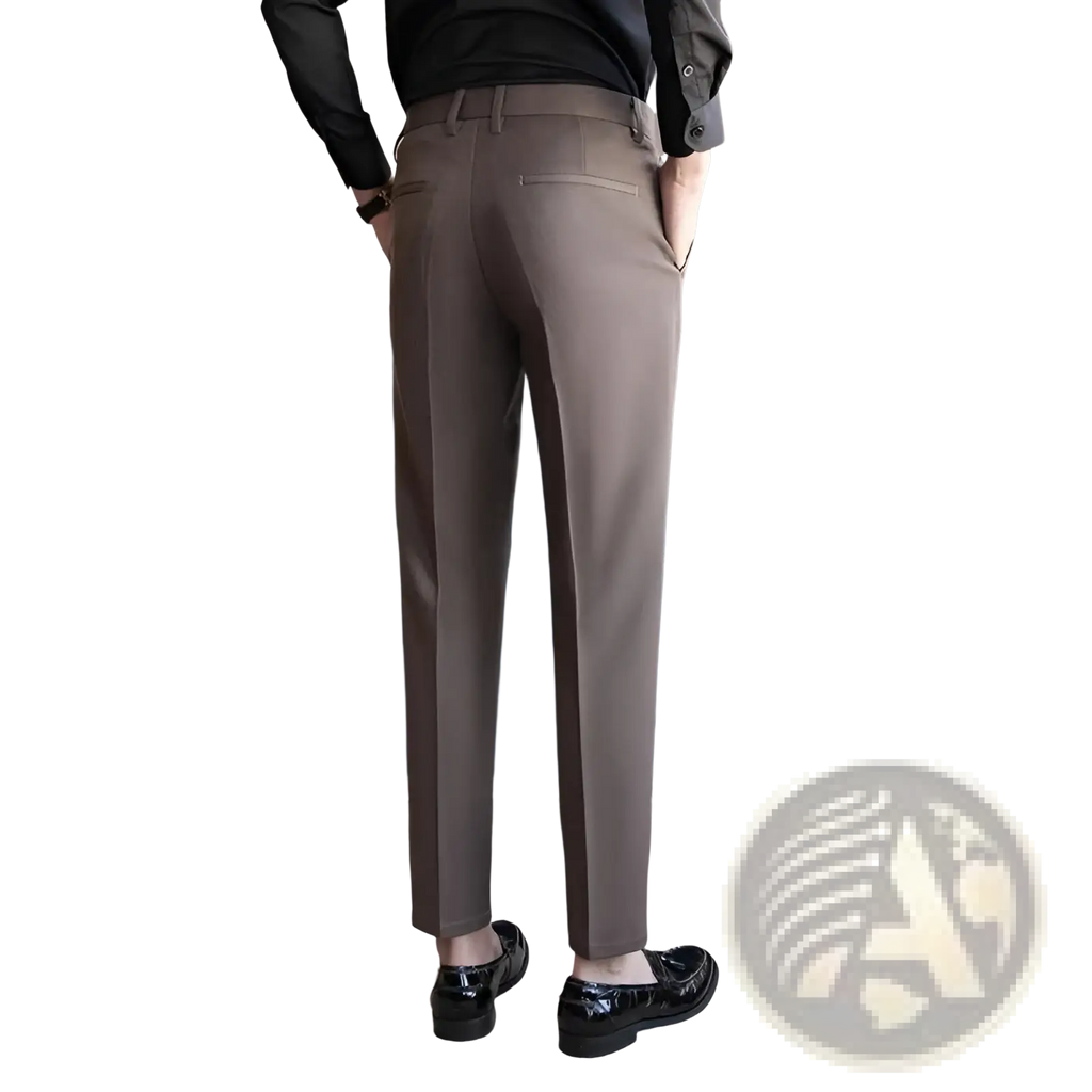 A pair of men’s slim fit British style tailored straight leg brown trousers with subtle stitching details and a modern cut
