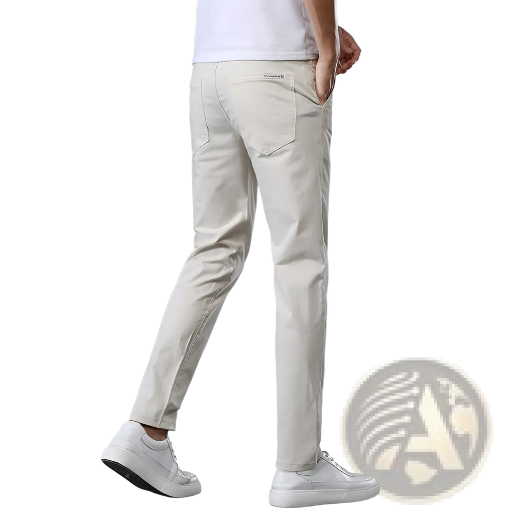 Beige slim fit elastic cotton chino pants with straight leg shown from the back featuring a subtle brand label on the pocket