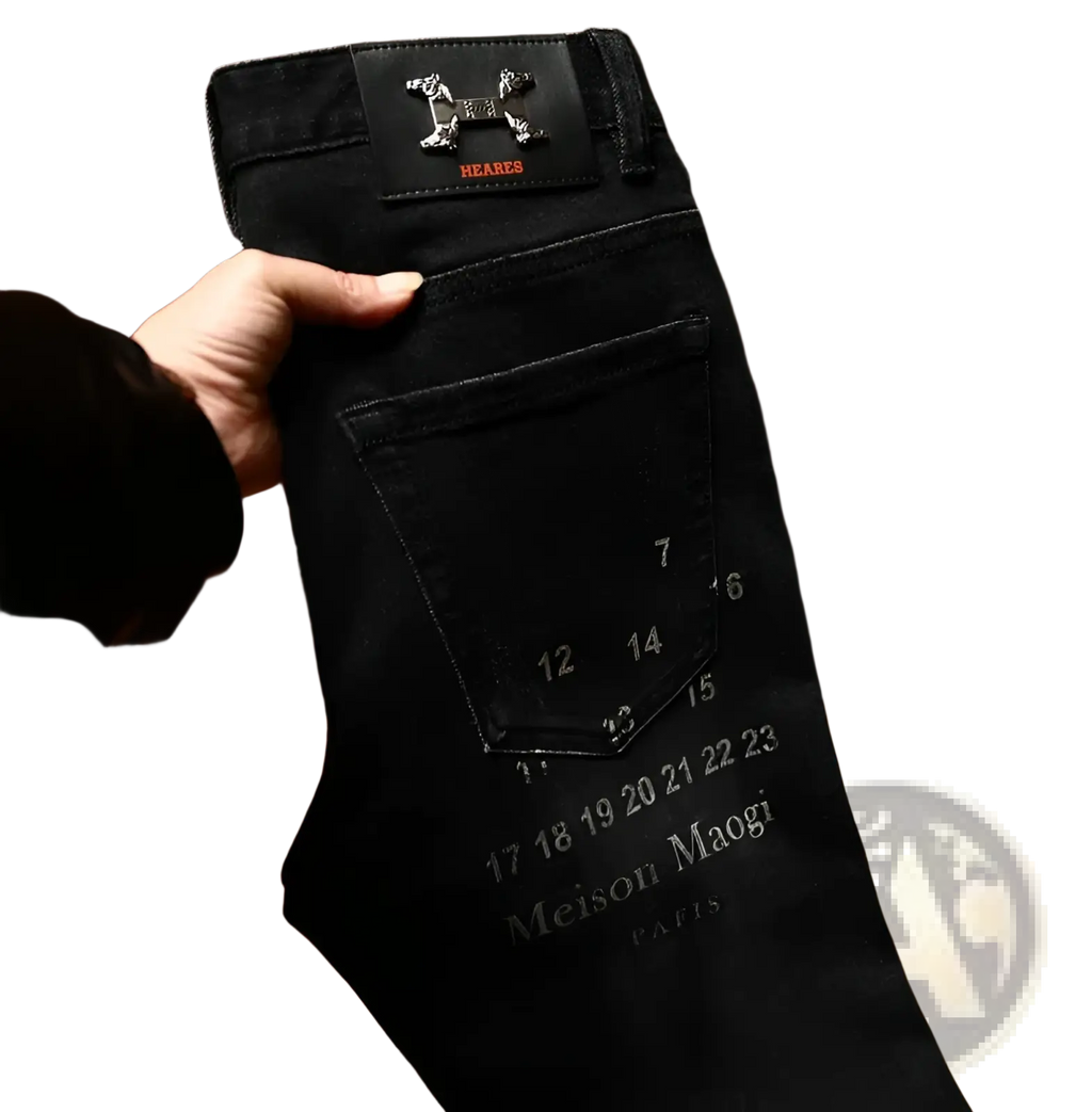 Back side of mens slim fit printed black denim jeans featuring a branded patch with embossed logo and red heares lettering