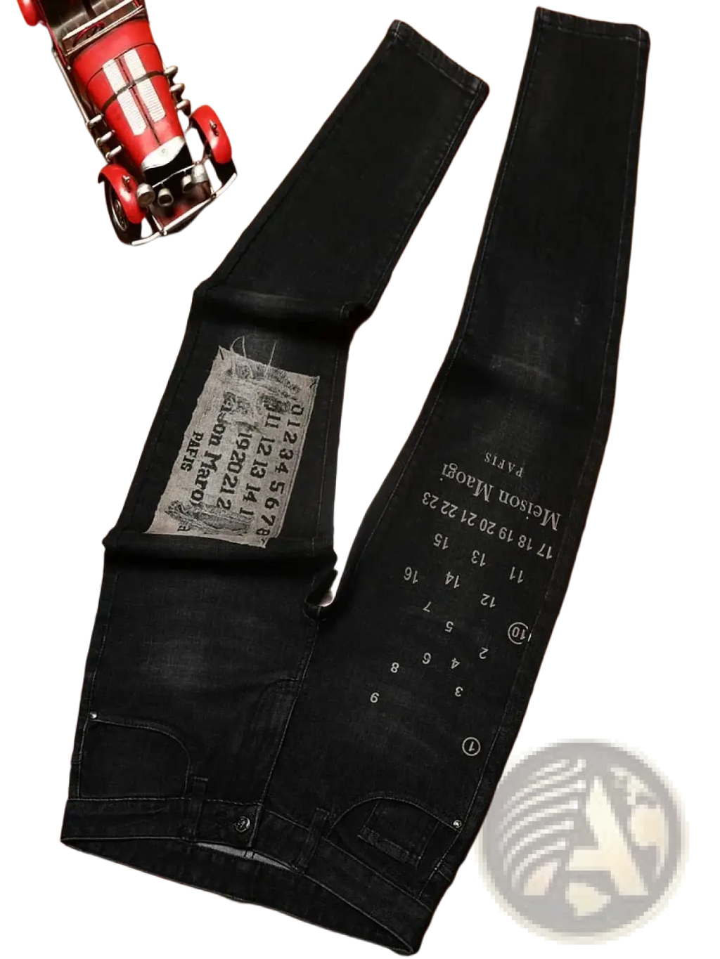 Mens slim fit black denim jeans in distressed faded style with white printed text and numbers along the leg