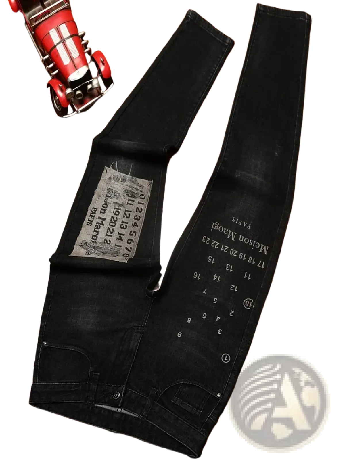 Mens slim fit black denim jeans in distressed faded style with white printed text and numbers along the leg