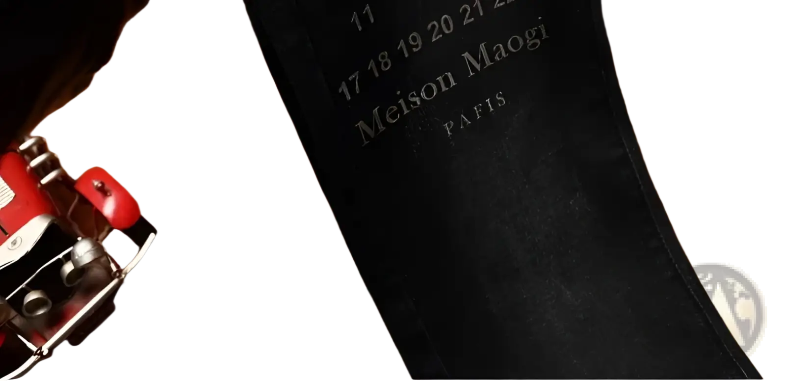 Black leather belt with embossed meison maogi paris text paired with mens slim fit printed black denim jeans