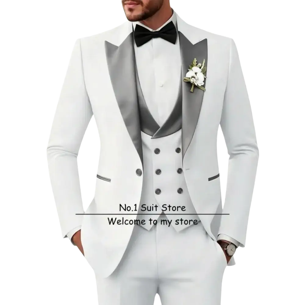 Men’s slim fit white tuxedo 3 piece suit with silver satin lapels, matching vest, black bow tie, and floral boutonniere