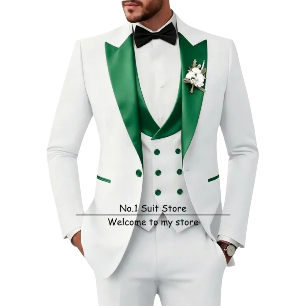 Men’s slim fit white tuxedo 3 piece suit with emerald green satin lapels and vest, black bow tie, and floral boutonniere