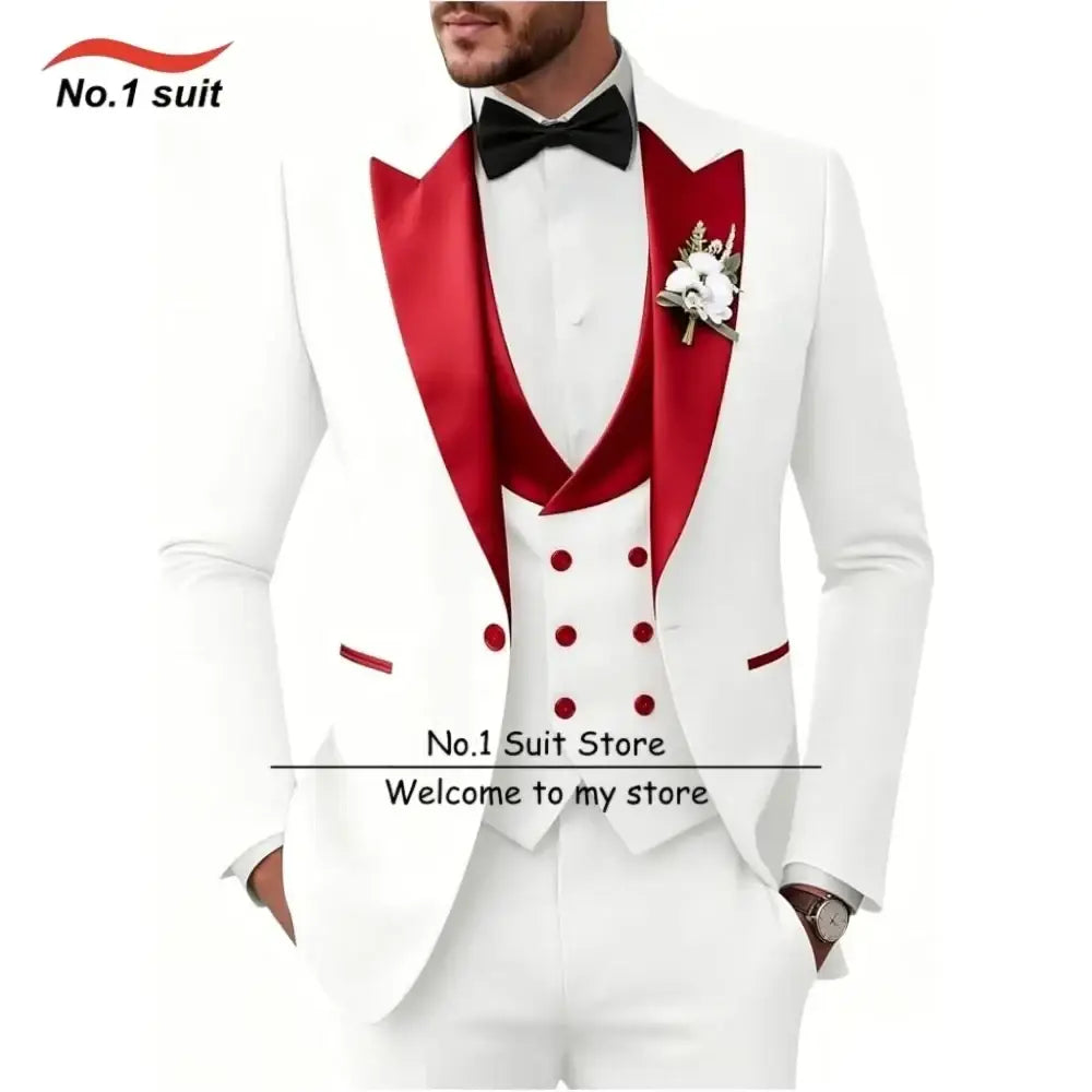 Men’s slim fit white tuxedo 3 piece suit with red satin lapels and buttons, black bow tie, and floral boutonniere
