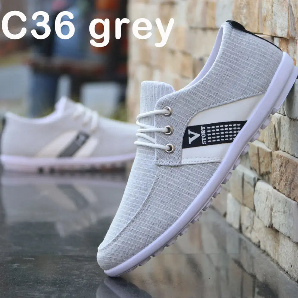 Men’s breathable soft sole canvas leisure sneakers in grey with textured fabric upper white laces and sport branding panel