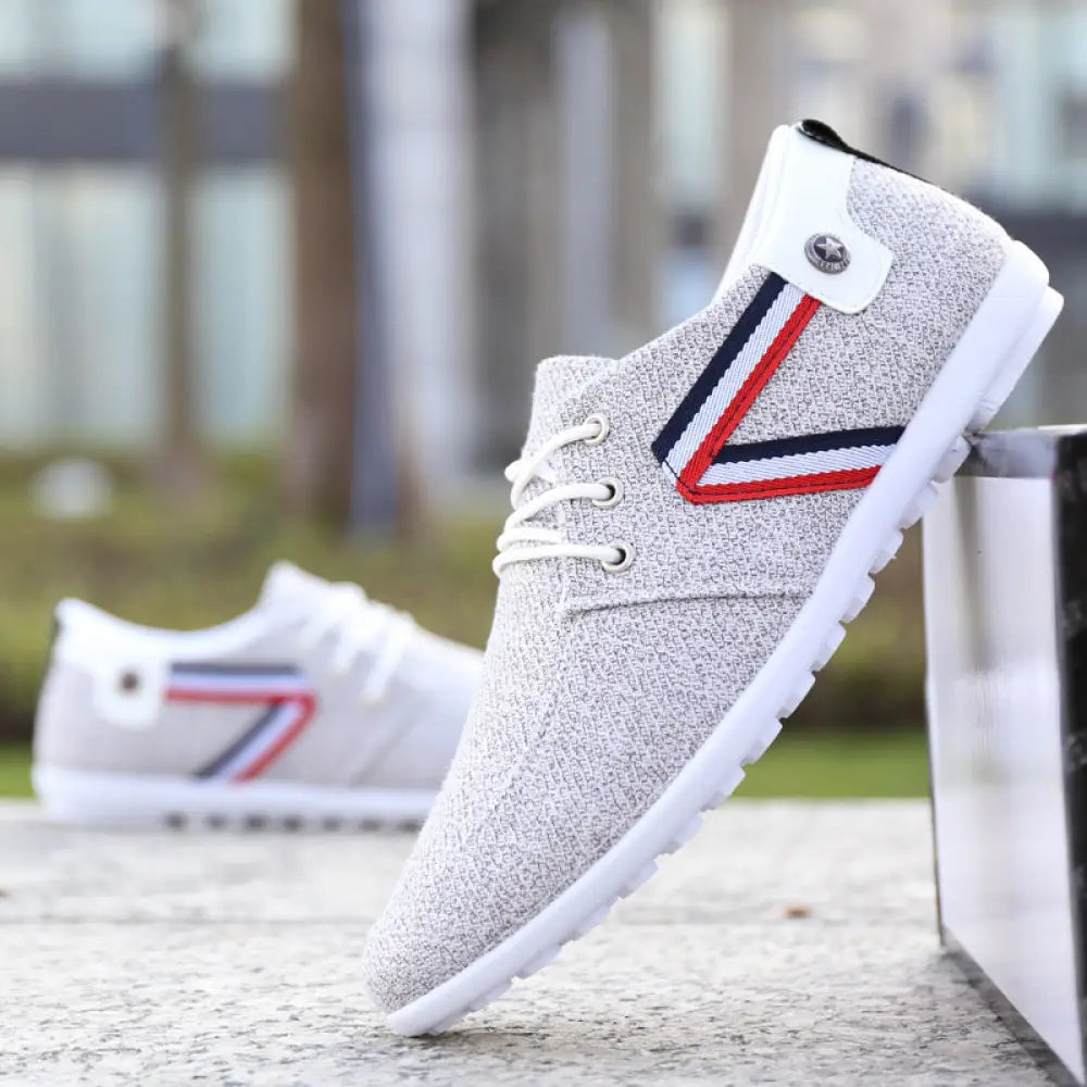 Men’s breathable soft sole gray canvas leisure sneaker with white laces and red navy striped v accent on white sole