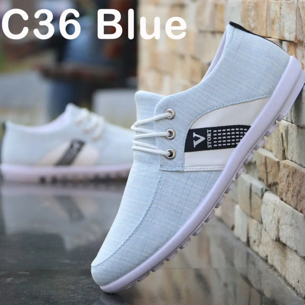 Men’s breathable soft sole canvas leisure sneakers in light blue with white laces and black logo panel on the side