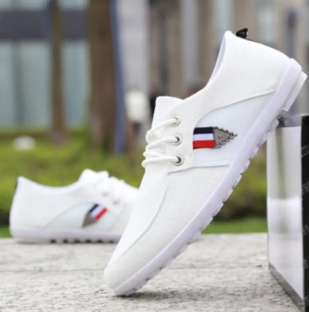Men’s breathable soft sole white canvas leisure sneakers with red white and blue flag emblem on the side